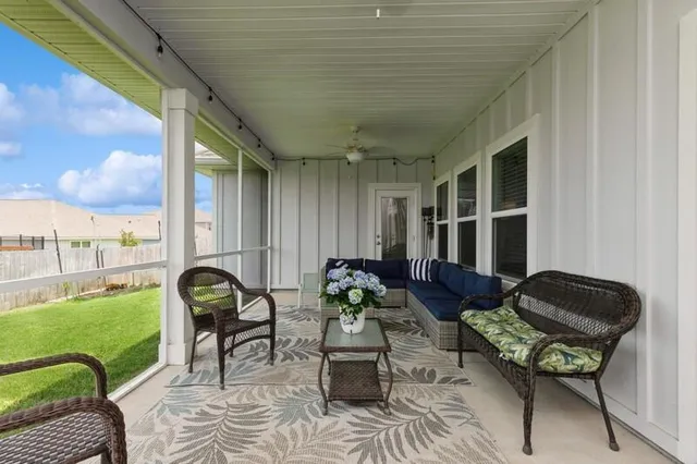 a view of an house with backyard space and balcony