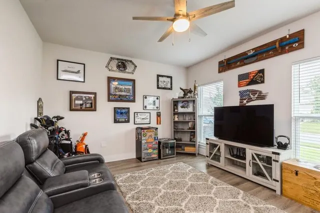 a living room with furniture and a flat screen tv