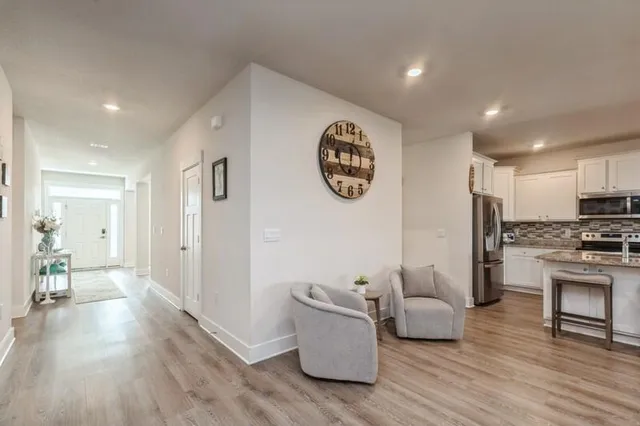 a living room with furniture and a wooden floor