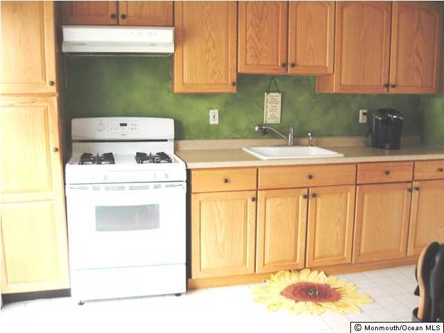 178 Greenwood Loop Road Brick, NJ 08724 - Photo 1 of 3 a kitchen with a stove a sink and a refrigerator