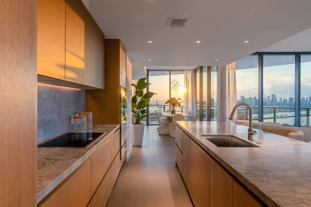 500 Alton Road, Unit 3903 04 Miami Beach, FL 33139 - Photo 12 of 72 a kitchen with counter top a sink a counter space appliances and cabinets