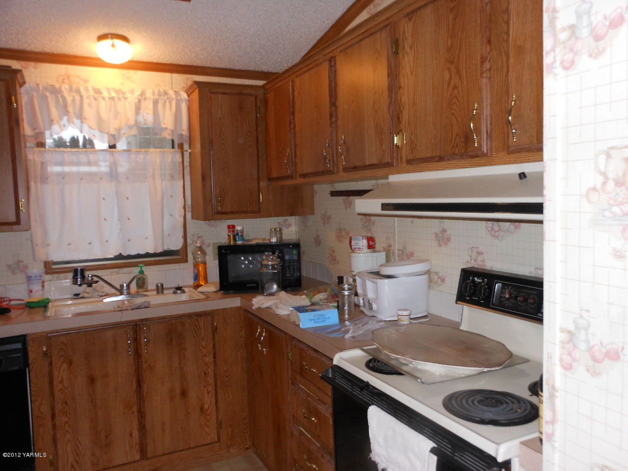 110 Sage Trail Road, Unit 40 Yakima, WA 98901 - Photo 3 of 10 a kitchen with a sink stove and cabinets