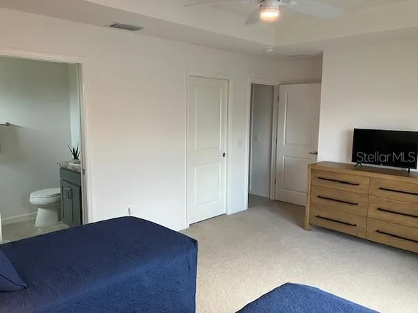a bedroom with a bed window and table