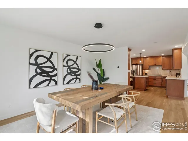 a dining room with furniture and kitchen view