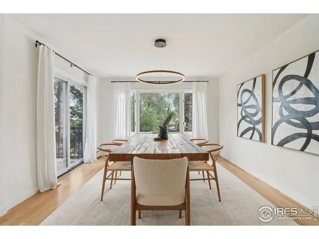 a dining room with furniture and wooden floor