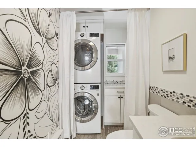 a utility room with multiple dryer and washer