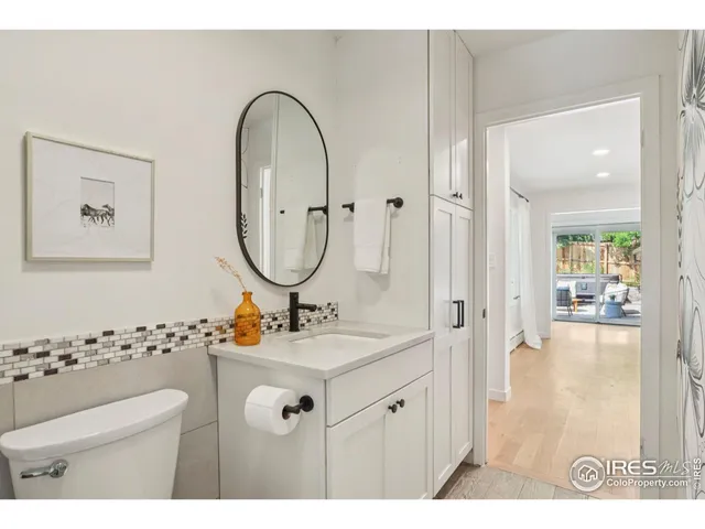 a bathroom with a sink mirror and vanity
