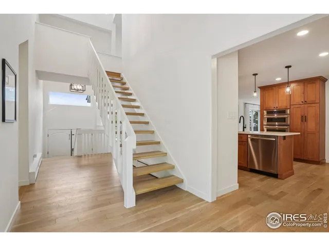 a view of a kitchen with wooden floor and electronic appliances