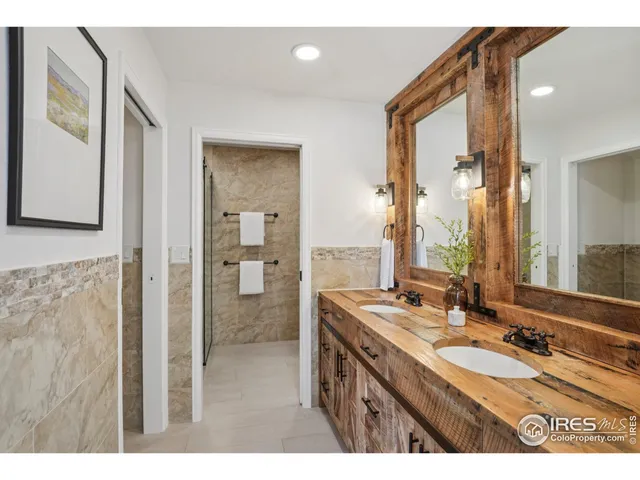 a bathroom with a granite countertop sink mirror and double