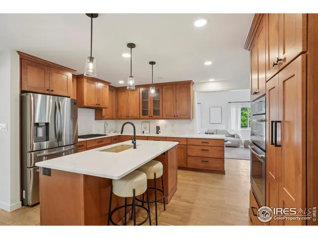 a kitchen with refrigerator a sink and cabinets