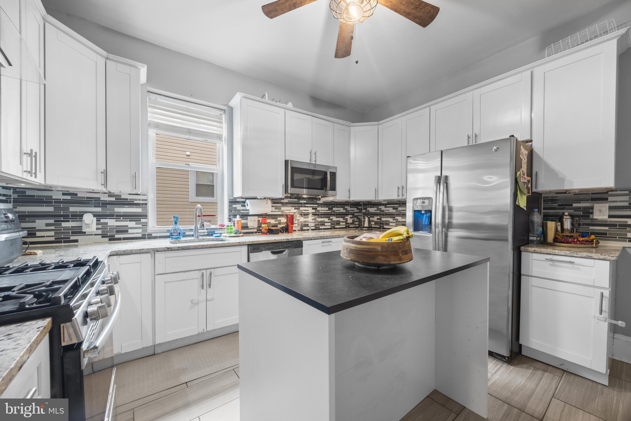 3814 Chatham Road Baltimore, MD 21215 - Photo 14 of 45 a kitchen with stainless steel appliances a stove refrigerator sink and microwave