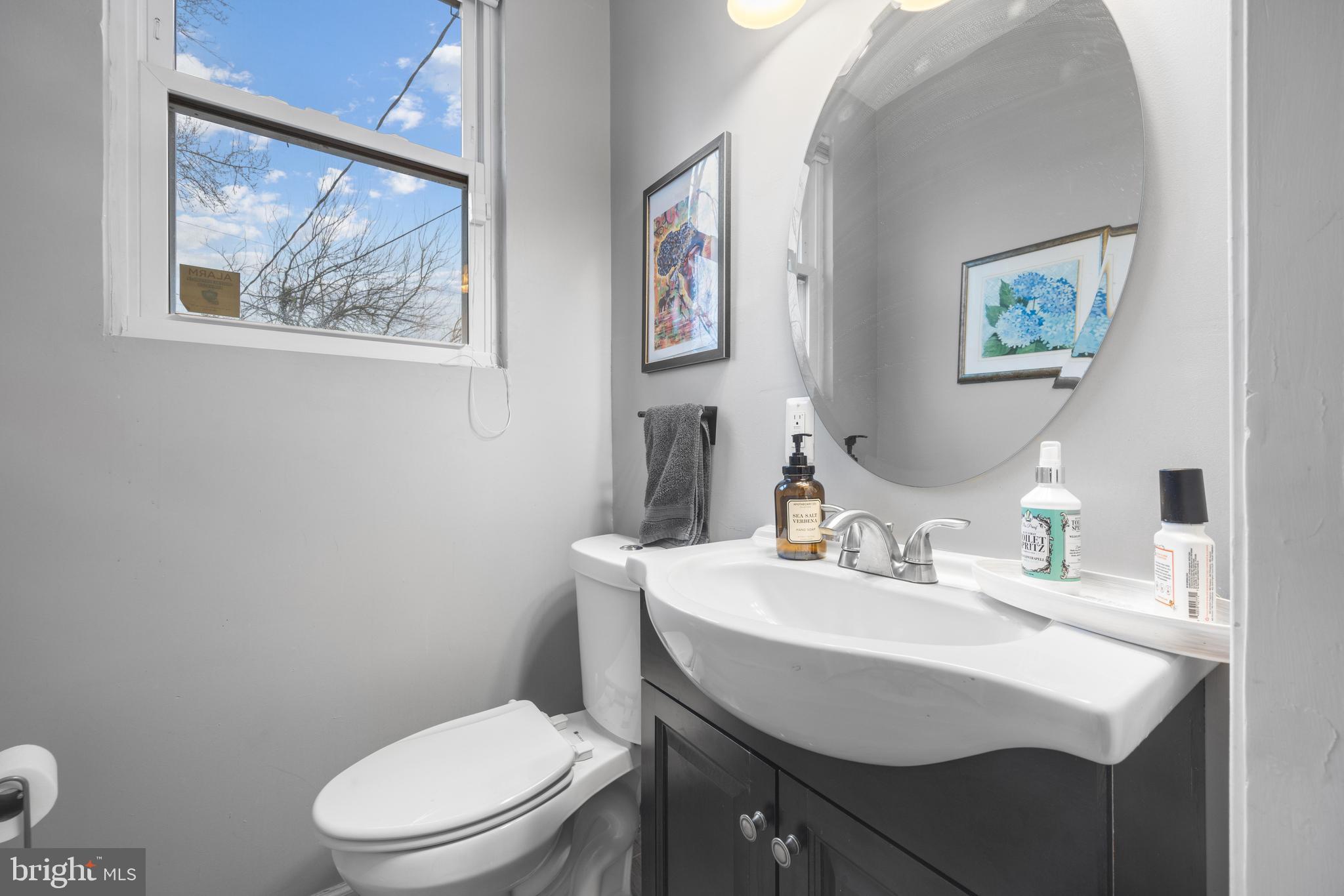 3814 Chatham Road Baltimore, MD 21215 - Photo 16 of 45 a bathroom with a toilet a sink and mirror
