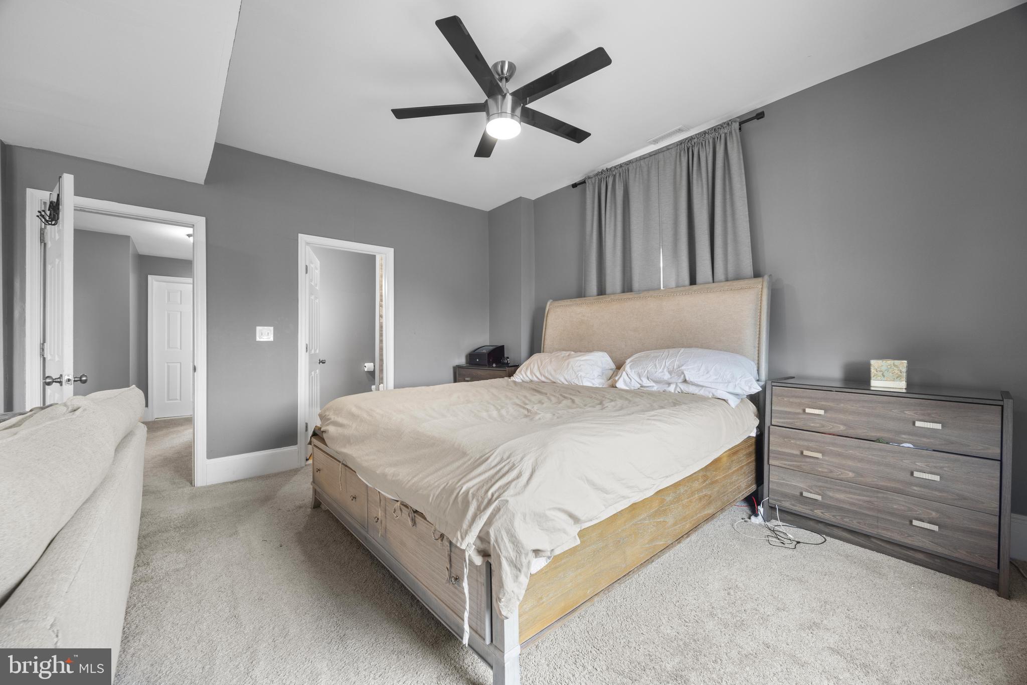 3814 Chatham Road Baltimore, MD 21215 - Photo 21 of 45 a spacious bedroom with a bed and a chandelier