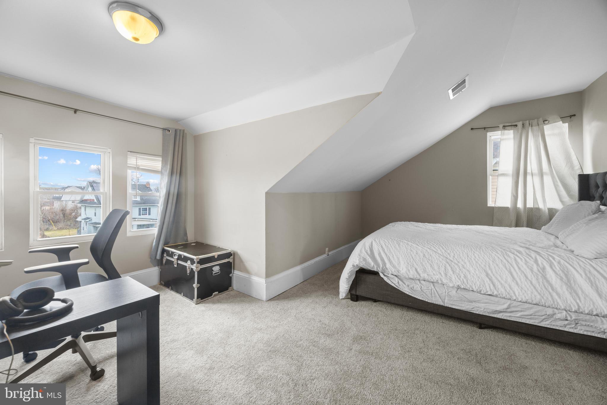 3814 Chatham Road Baltimore, MD 21215 - Photo 25 of 45 a bed sitting in a room next to a window