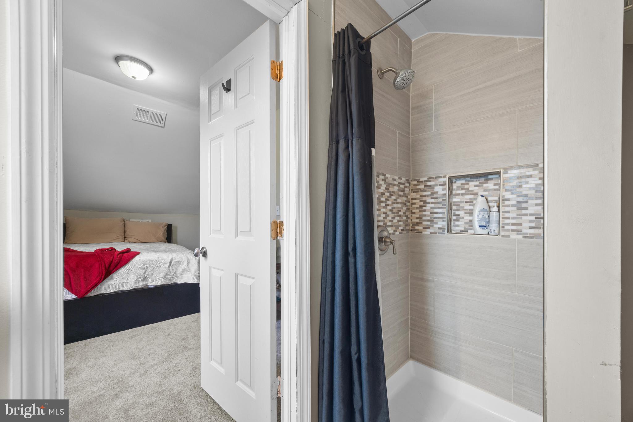 3814 Chatham Road Baltimore, MD 21215 - Photo 29 of 45 a bathroom with a bathtub and a shower