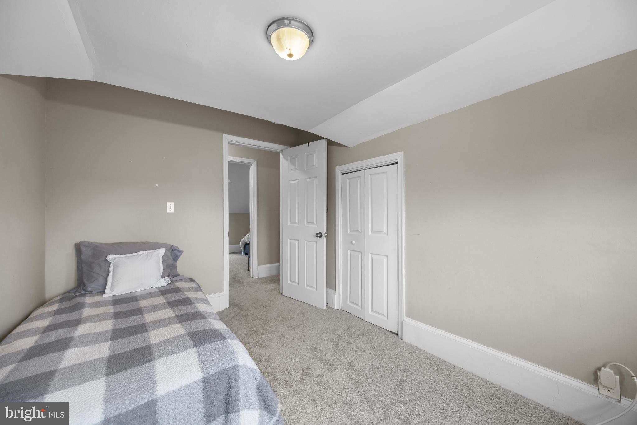 3814 Chatham Road Baltimore, MD 21215 - Photo 30 of 45 a bedroom with a bed and a lamp