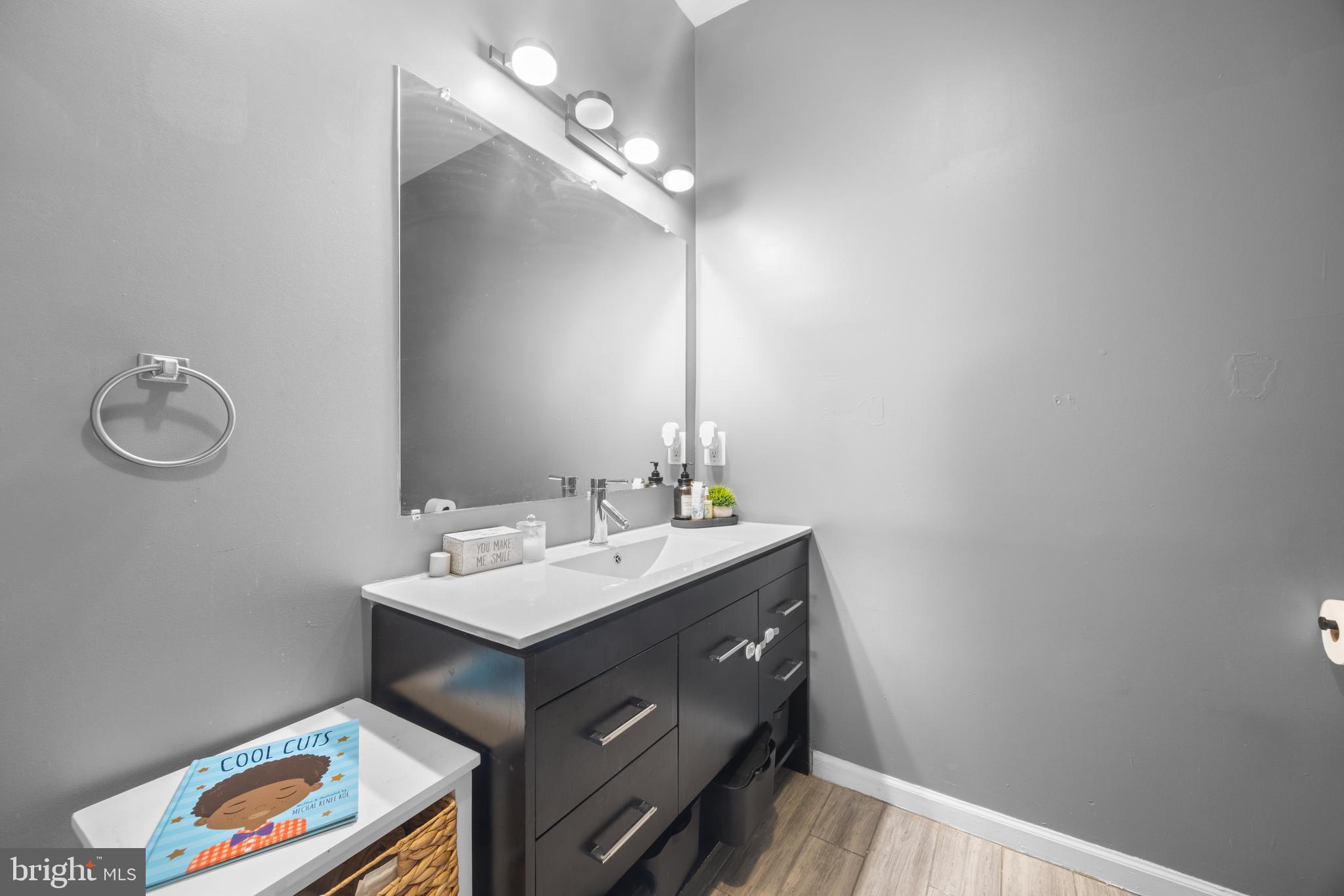 3814 Chatham Road Baltimore, MD 21215 - Photo 31 of 45 a bathroom with a sink vanity and a mirror