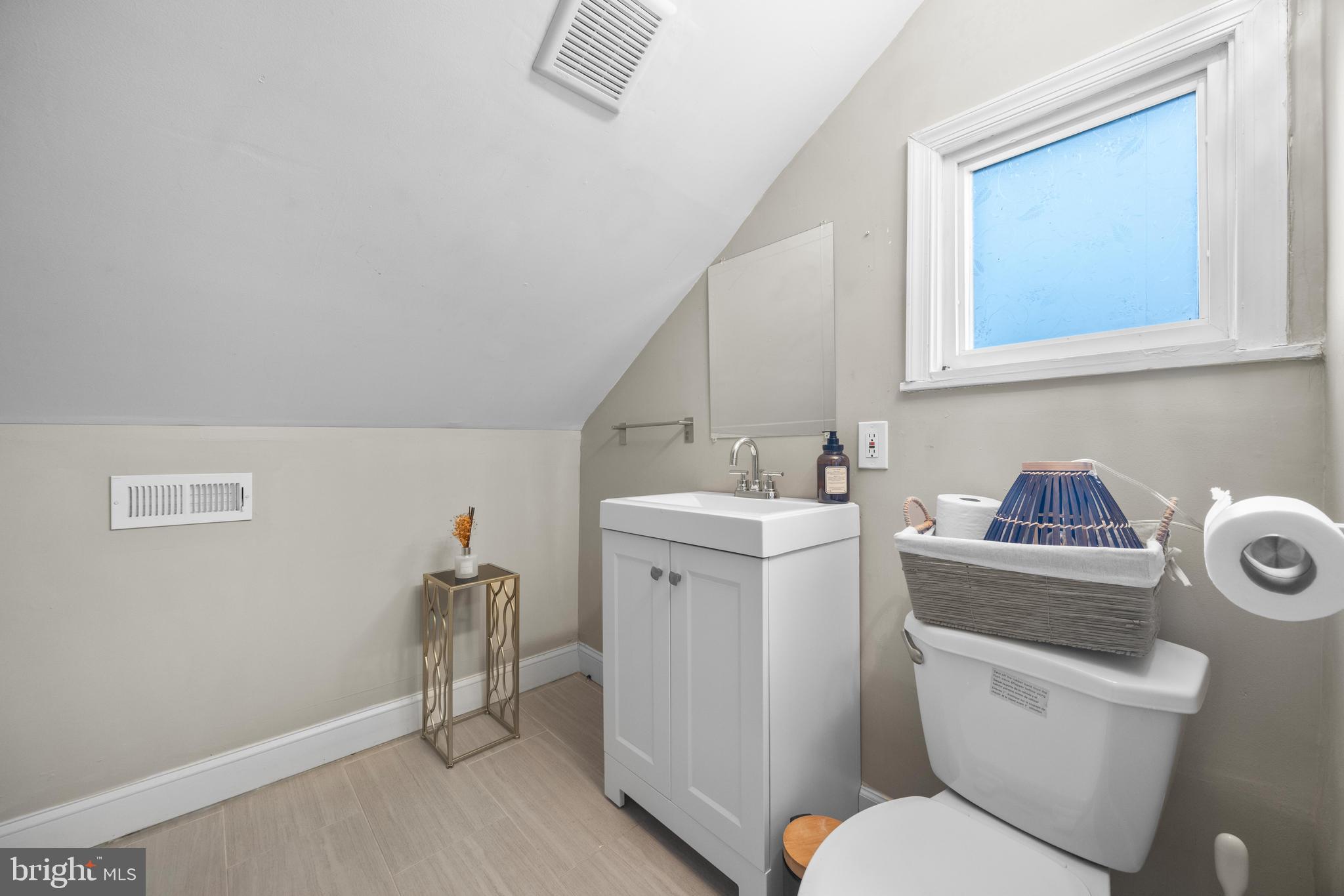 3814 Chatham Road Baltimore, MD 21215 - Photo 32 of 45 a bathroom with a toilet sink and mirror