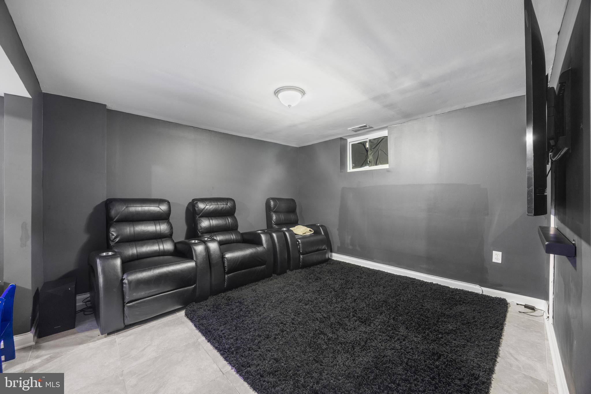 3814 Chatham Road Baltimore, MD 21215 - Photo 36 of 45 a room with gym equipment and a flat screen tv