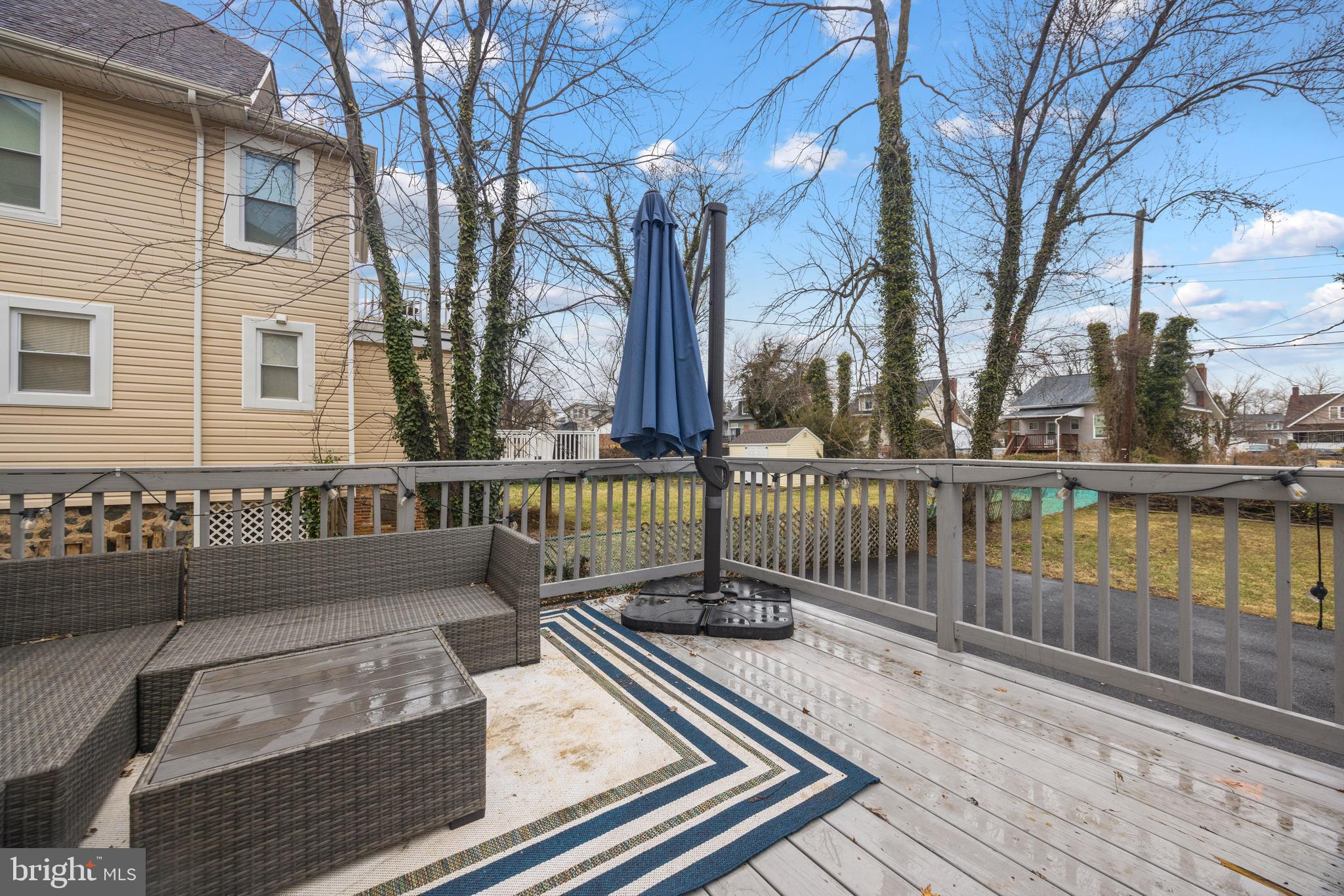 3814 Chatham Road Baltimore, MD 21215 - Photo 39 of 45 a view of a brick house with large windows and a table