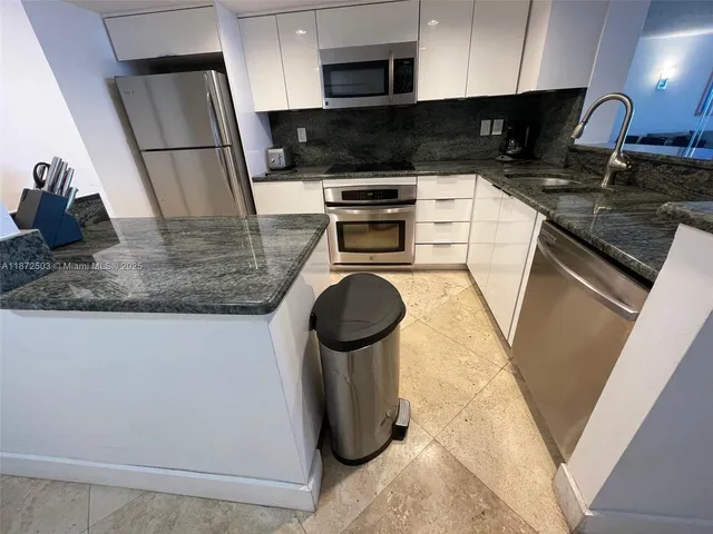 a kitchen with refrigerator and stove