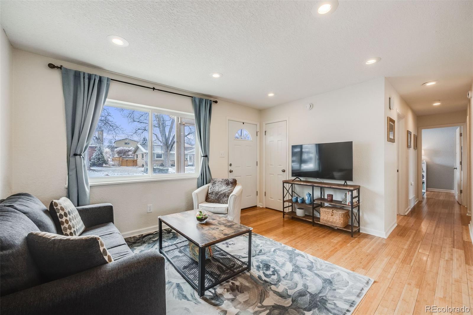 a living room with furniture and a flat screen tv