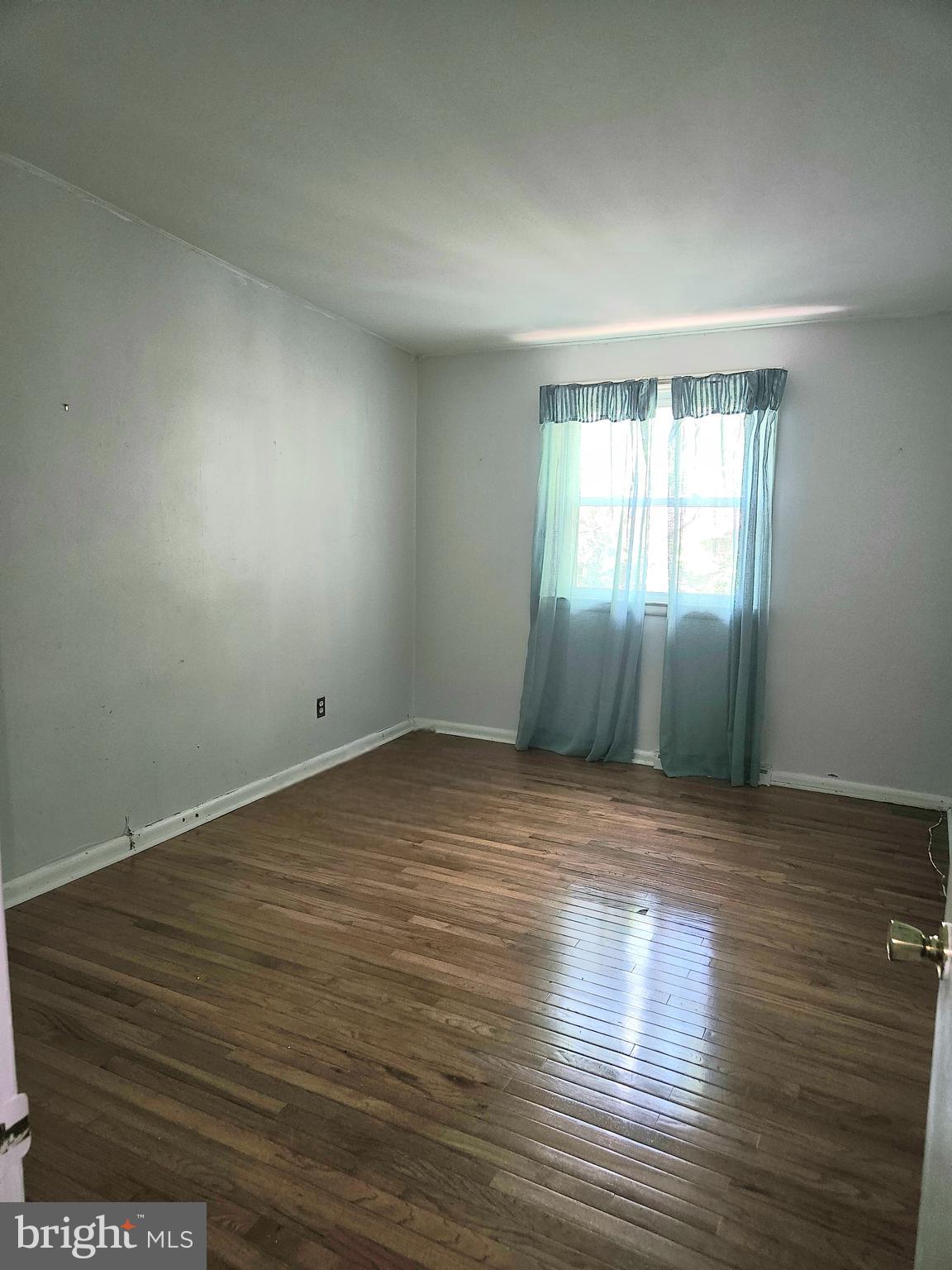 148 Church Road Elkins Park, PA 19027 - Photo 17 of 33 an empty room with wooden floor and windows