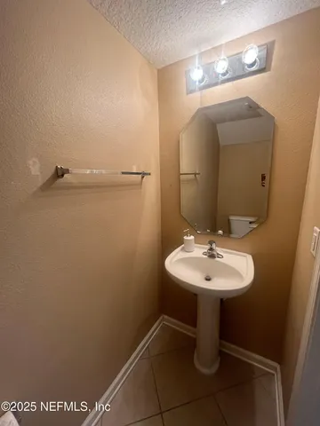 a bathroom with a sink a mirror and vanity