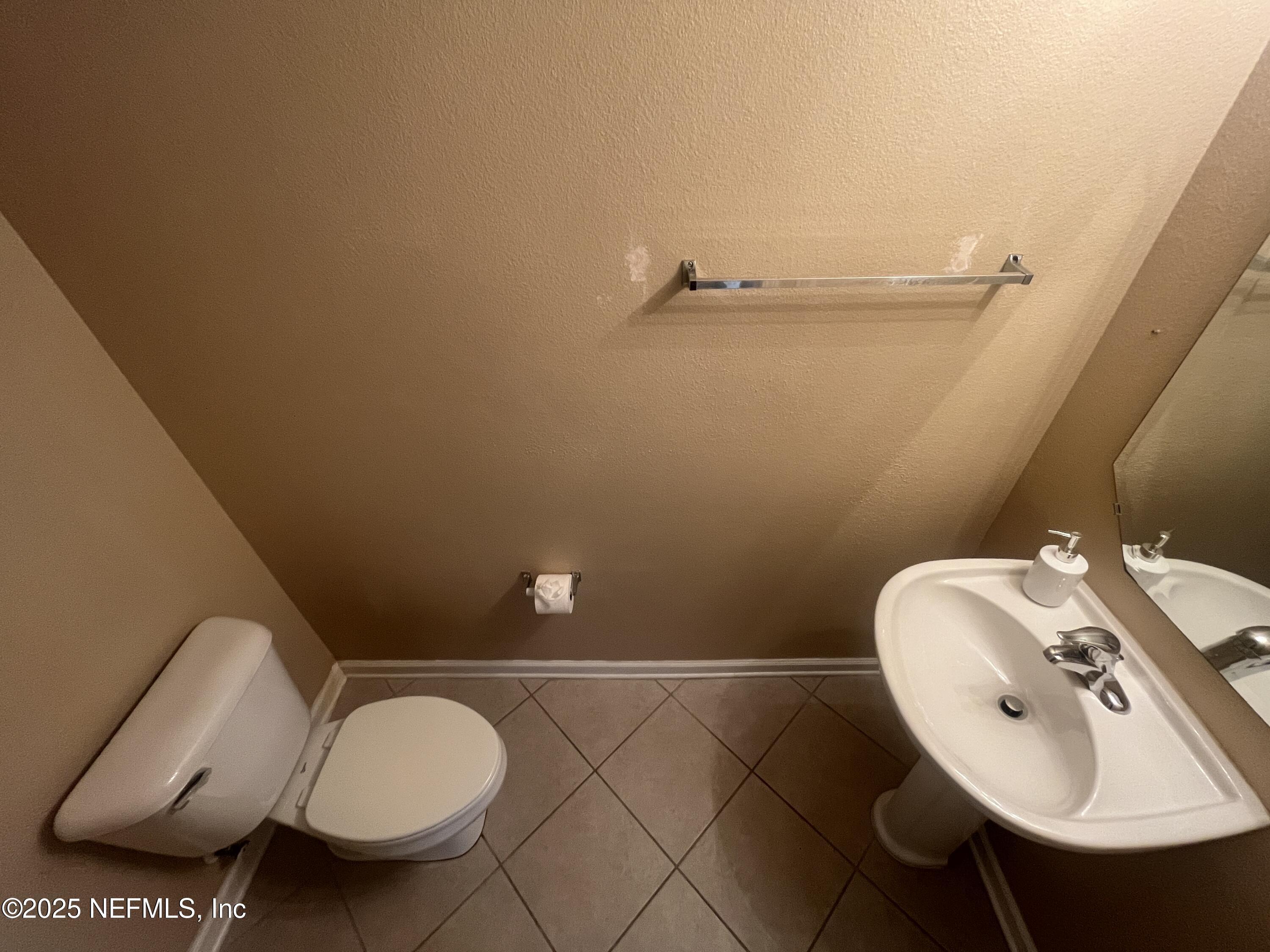 1500 Calming Water Drive, Unit 5201 Fleming Island, FL 32003 - Photo 15 of 39 a bathroom with a sink mirror and toilet