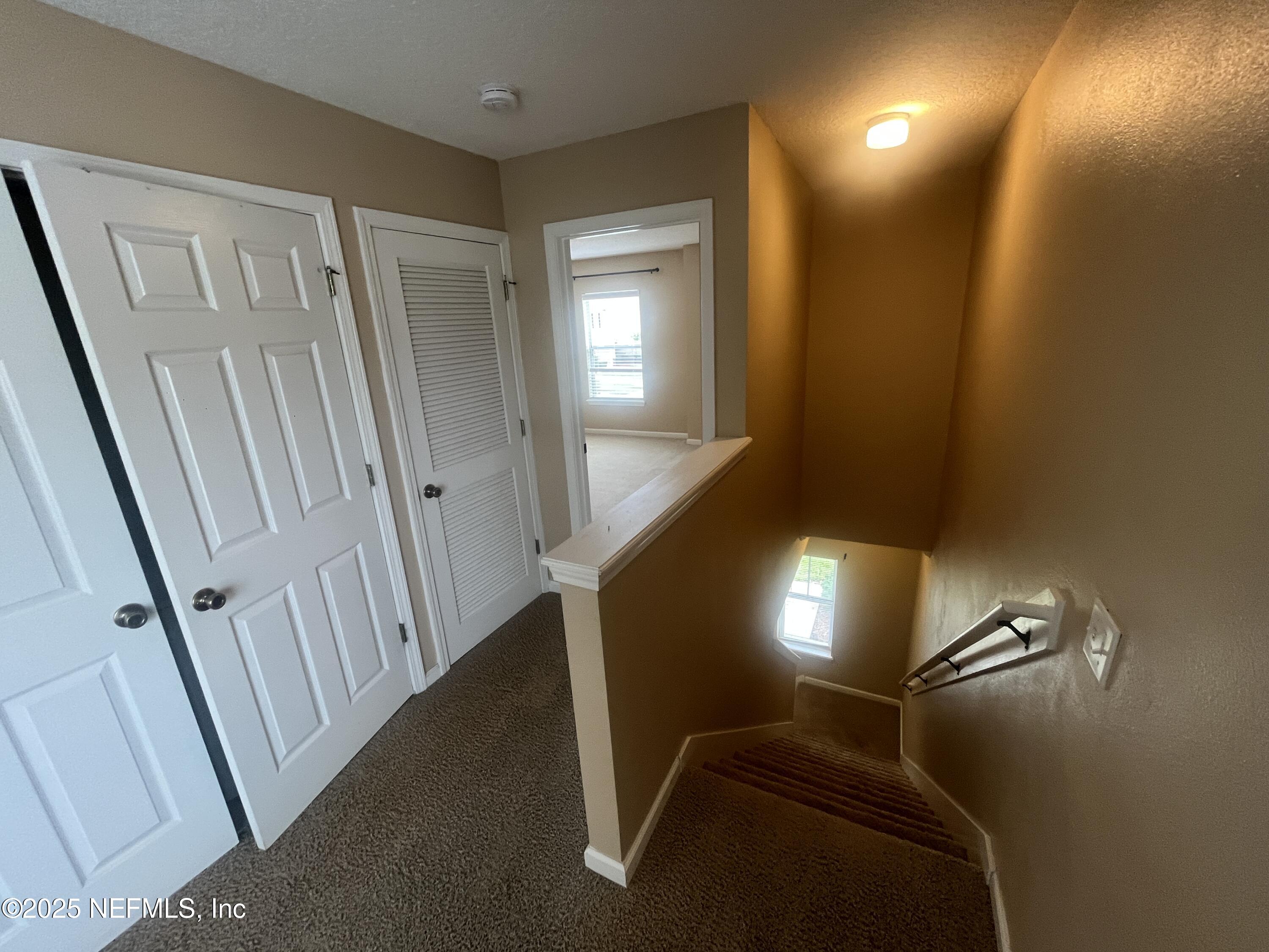 1500 Calming Water Drive, Unit 5201 Fleming Island, FL 32003 - Photo 17 of 39 a view of staircase with lots of frames on wall