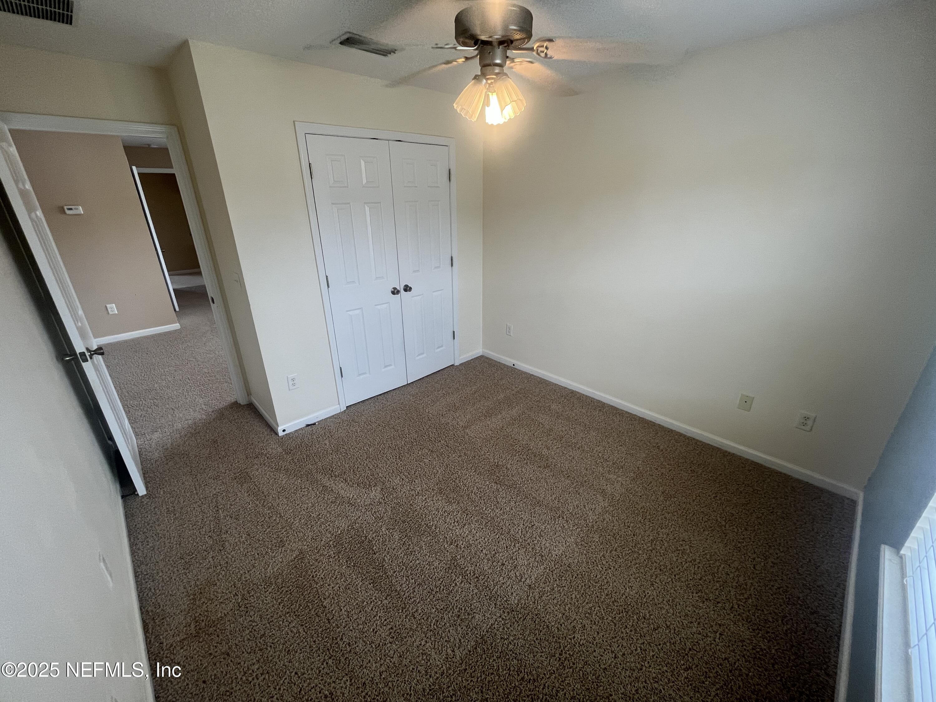 1500 Calming Water Drive, Unit 5201 Fleming Island, FL 32003 - Photo 19 of 39 an empty room with a bathroom and a fan