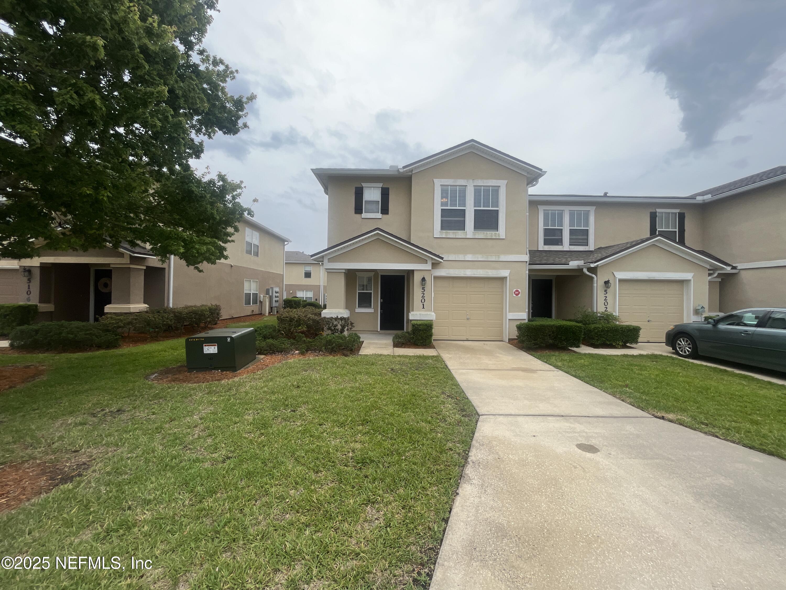 1500 Calming Water Drive, Unit 5201 Fleming Island, FL 32003 - Photo 2 of 39 a front view of a house with a yard and porch