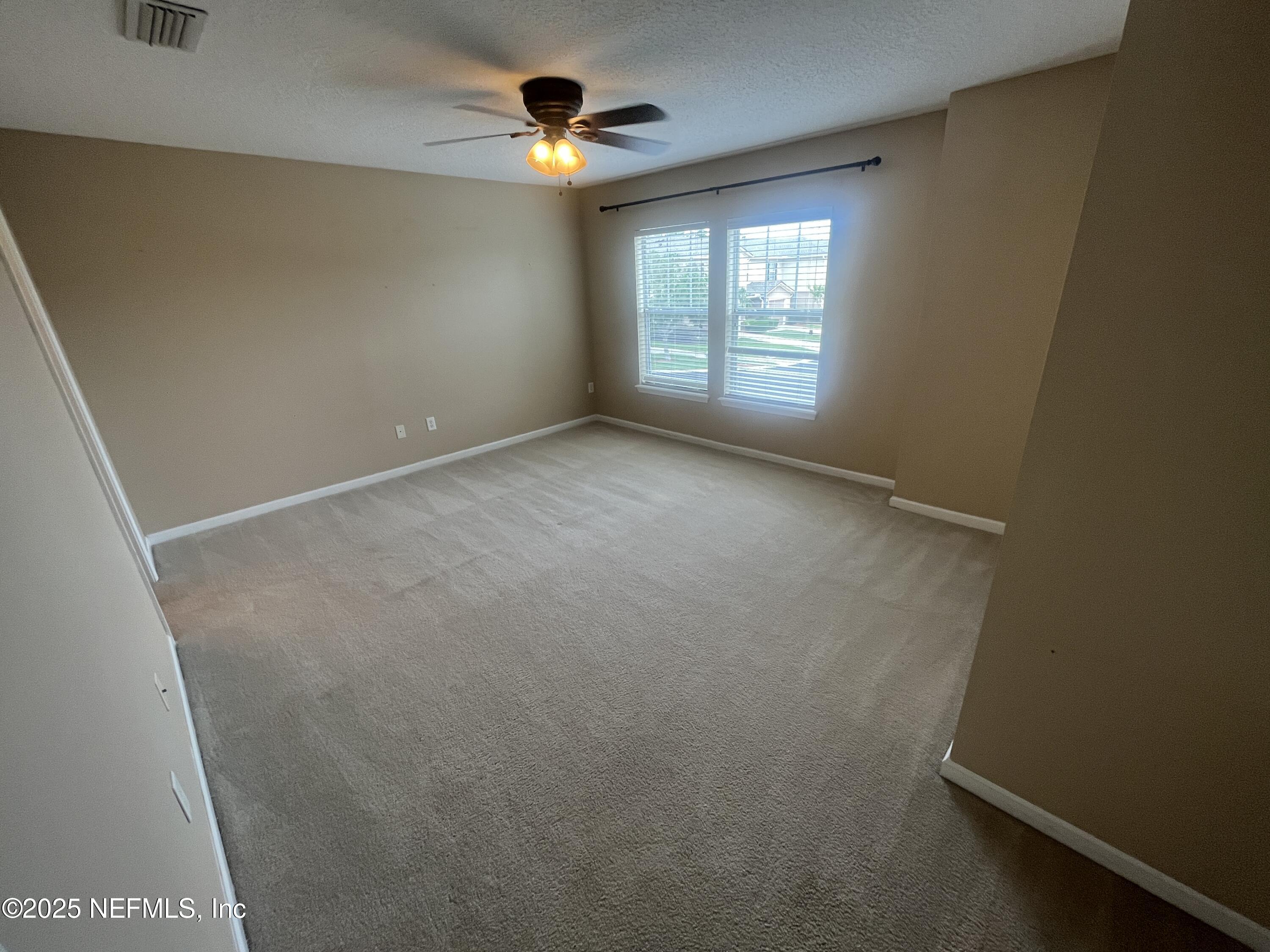 1500 Calming Water Drive, Unit 5201 Fleming Island, FL 32003 - Photo 24 of 39 an empty room with windows and closet