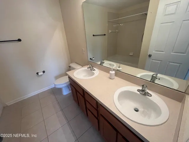 a bathroom with a tub a mirror and a shower
