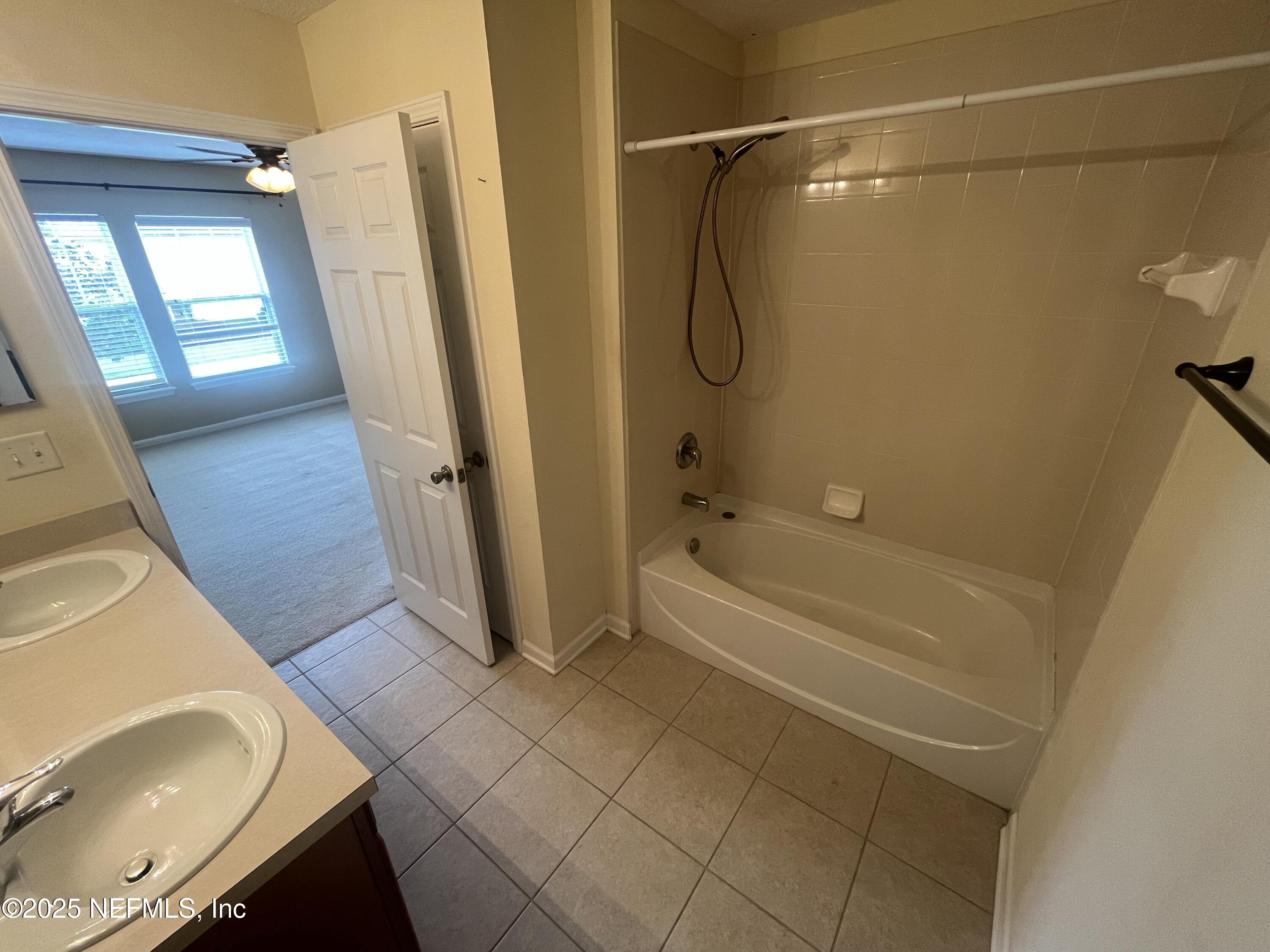 1500 Calming Water Drive, Unit 5201 Fleming Island, FL 32003 - Photo 26 of 39 a bathroom with a tub a mirror and a shower