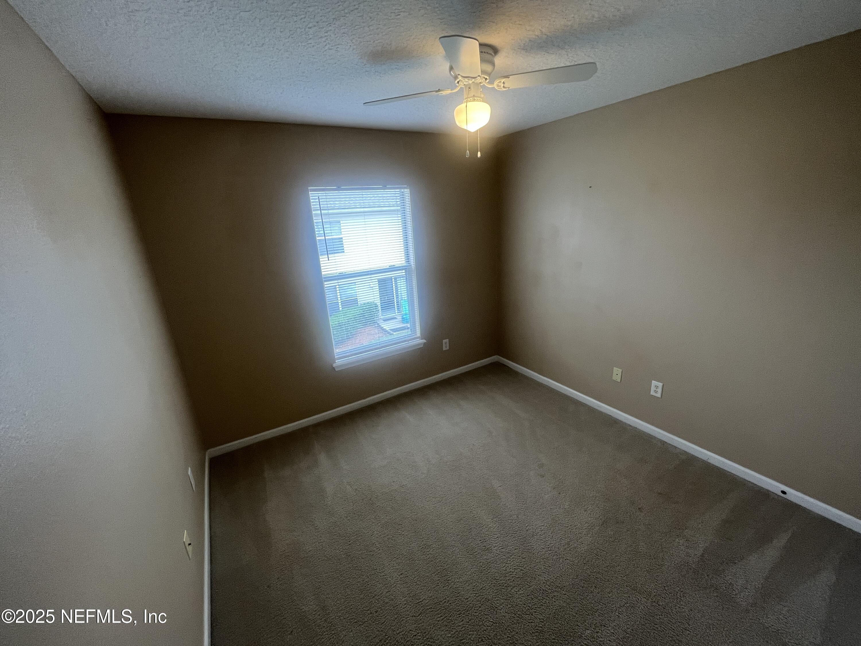 1500 Calming Water Drive, Unit 5201 Fleming Island, FL 32003 - Photo 33 of 39 an empty room with a window