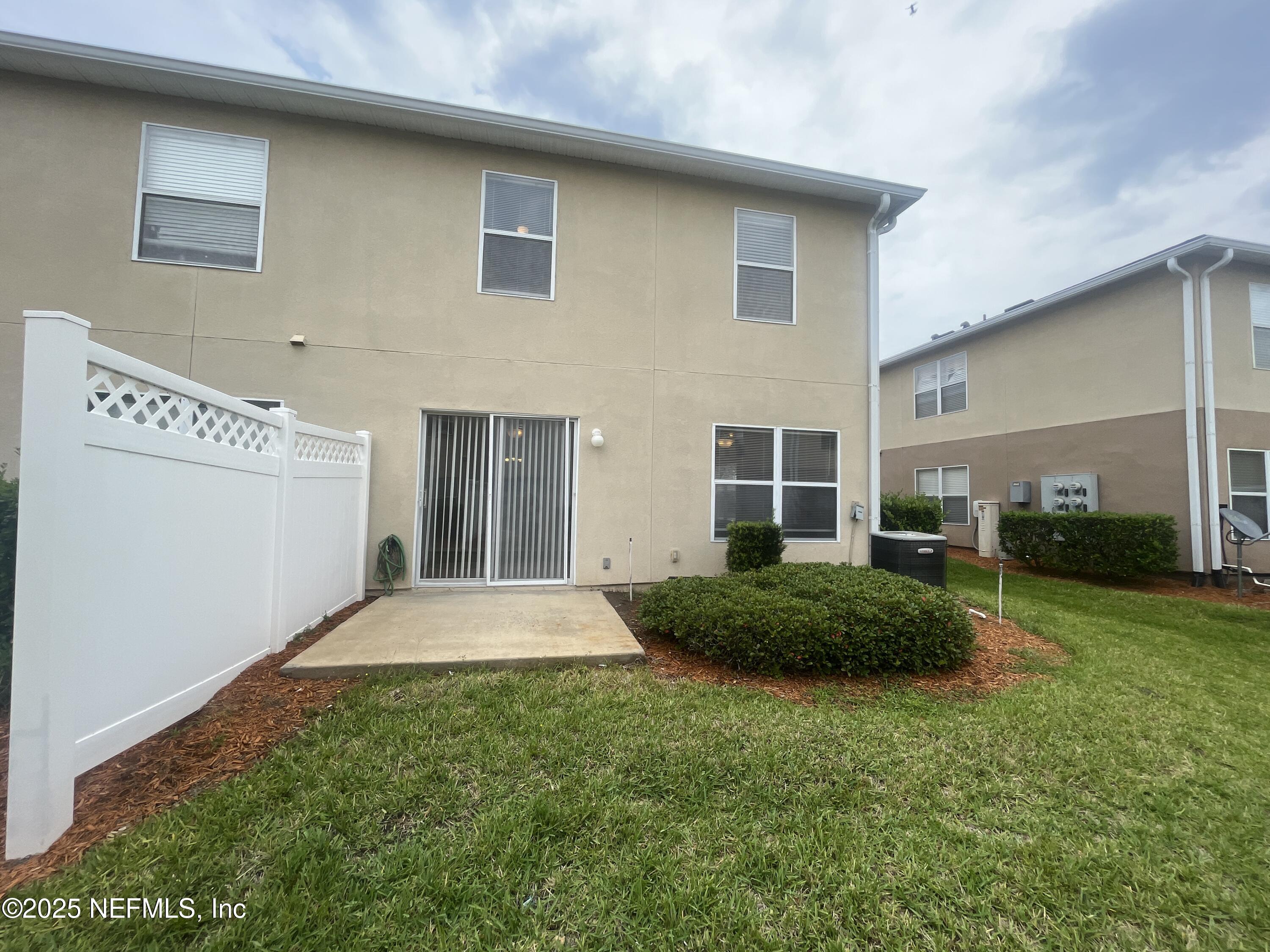 1500 Calming Water Drive, Unit 5201 Fleming Island, FL 32003 - Photo 38 of 39 a front view of a house with garage and plants