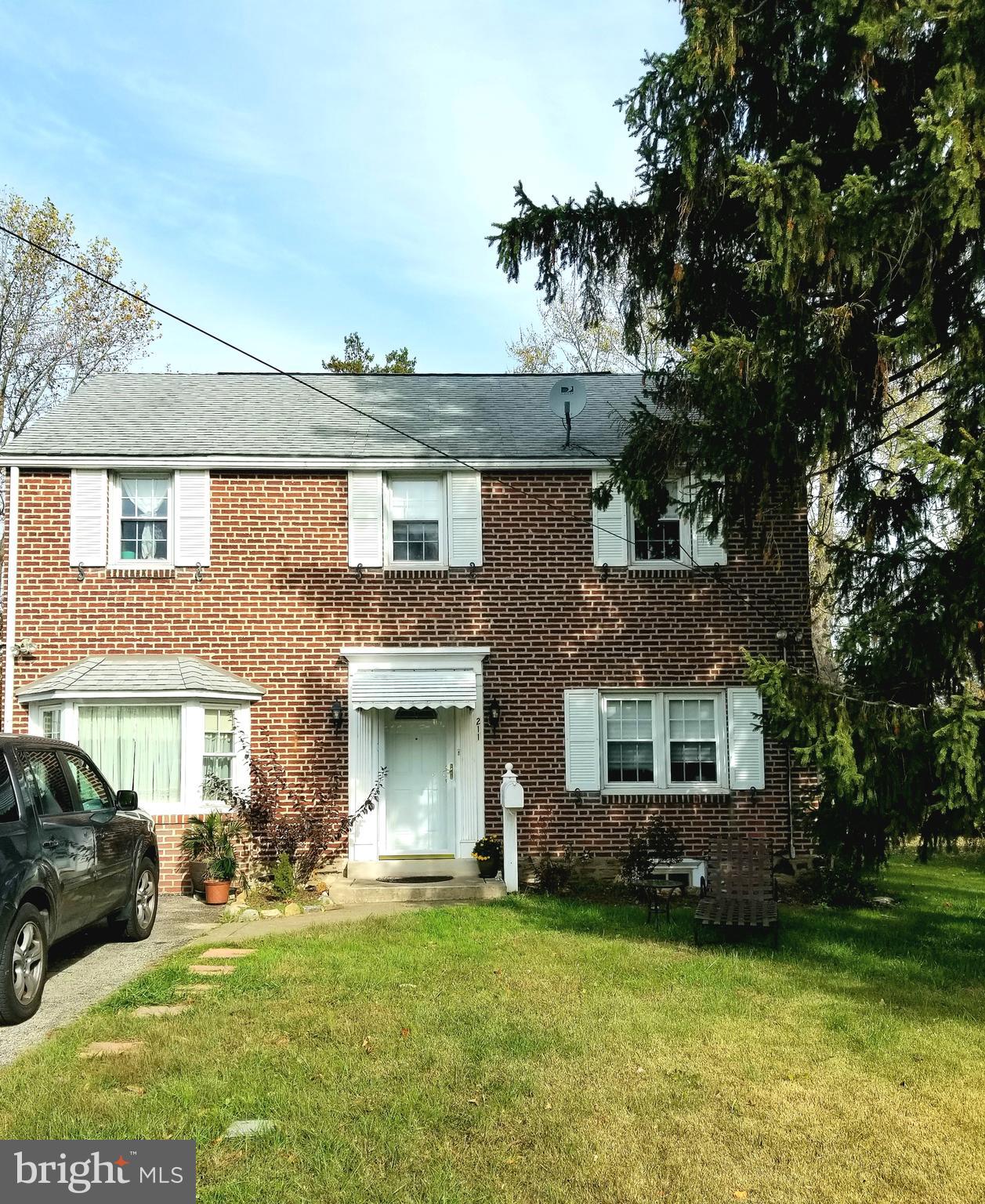 211 Ridley Drive Wallingford, PA 19086 - Photo 1 of 12 a view of a yard in front of a house