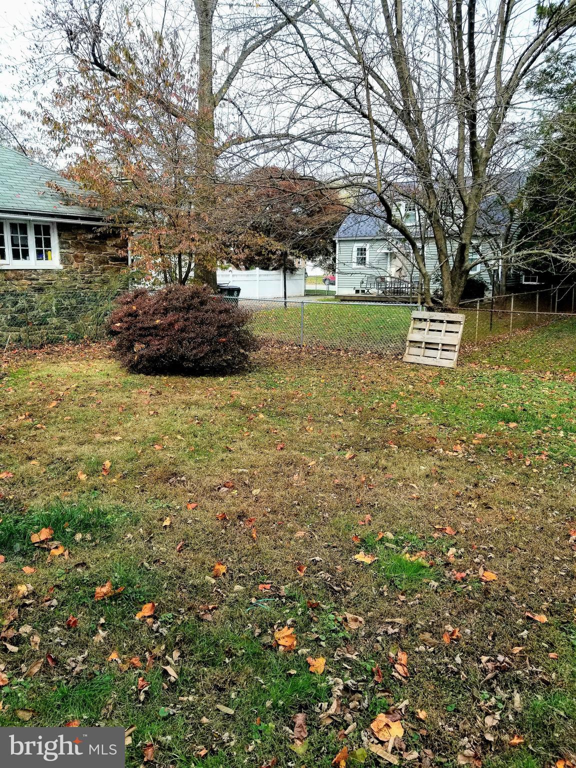 211 Ridley Drive Wallingford, PA 19086 - Photo 2 of 12 a front view of a house with a garden and tree
