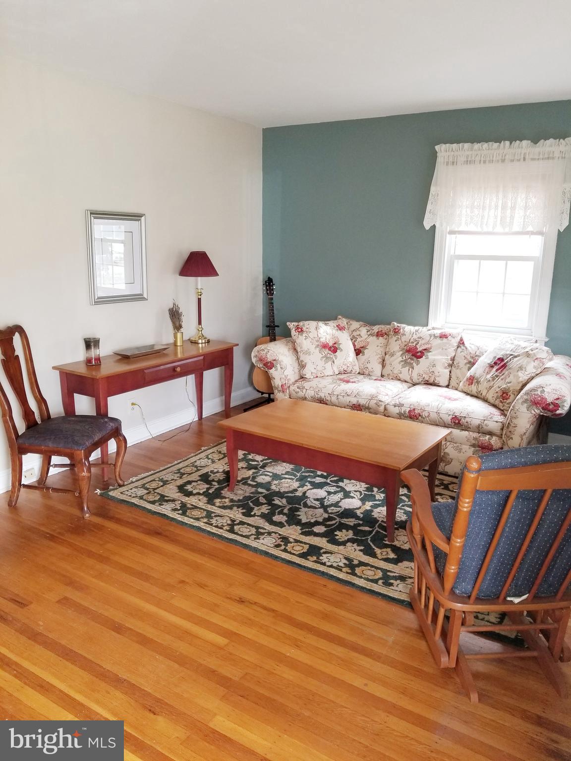 211 Ridley Drive Wallingford, PA 19086 - Photo 3 of 12 a living room with furniture a rug and a window