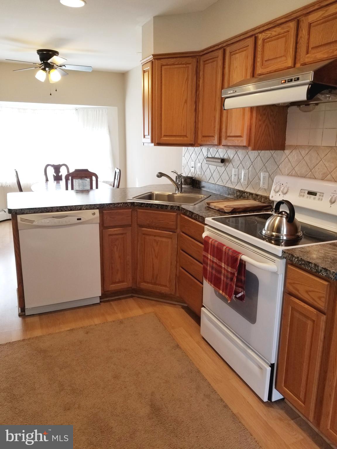 211 Ridley Drive Wallingford, PA 19086 - Photo 4 of 12 a kitchen with stainless steel appliances granite countertop a stove and a sink