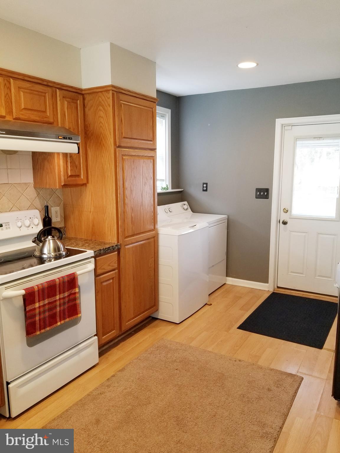 211 Ridley Drive Wallingford, PA 19086 - Photo 5 of 12 a kitchen with stainless steel appliances a stove a microwave and a refrigerator
