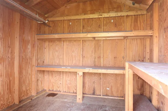 a view of kitchen with wooden cabinets
