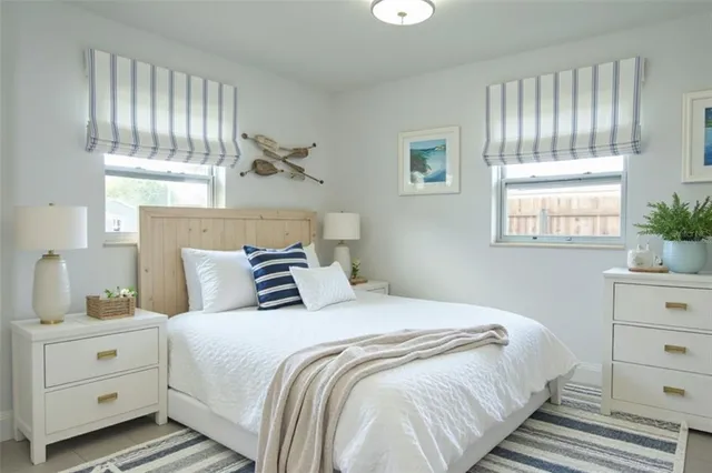 a bedroom with a bed and a window dresser