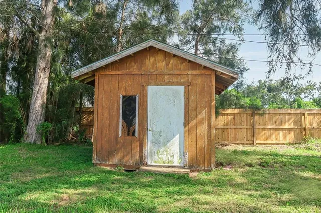 a view of backyard with small cabin
