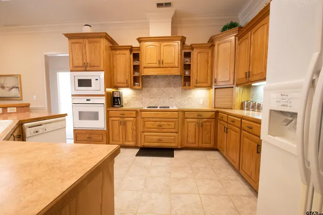 a kitchen with stainless steel appliances a stove a sink and a refrigerator