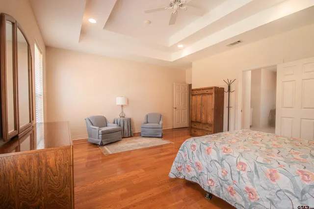 a bedroom with furniture and a large mirror