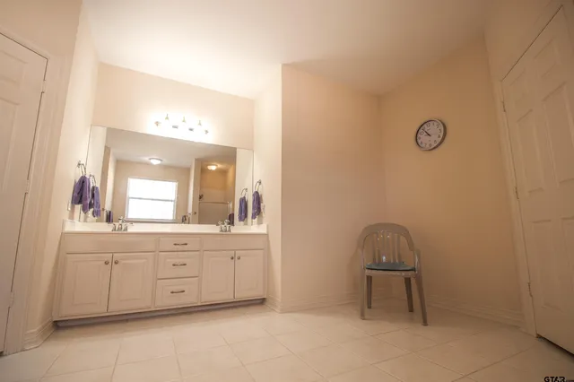 a bathroom with a sink a light fixture and a mirror