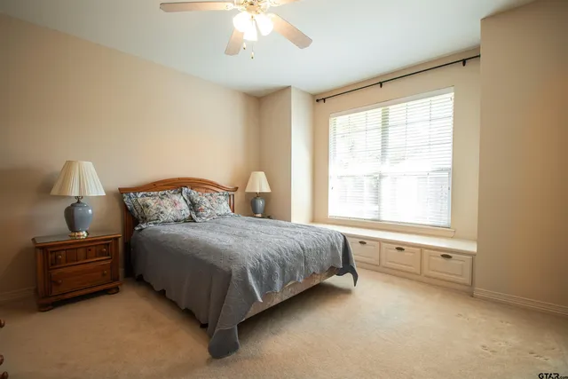 a bedroom with a bed and a window