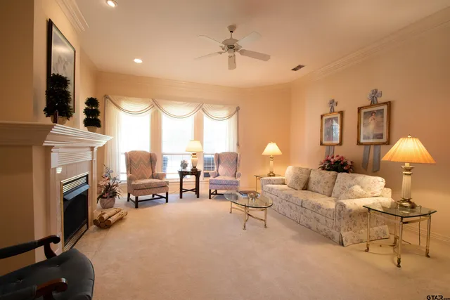 a living room with furniture a fireplace and a chandelier